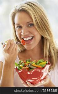 Young Woman Eating Fresh Salad