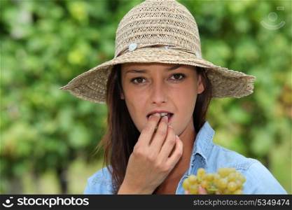 young woman eating grapes