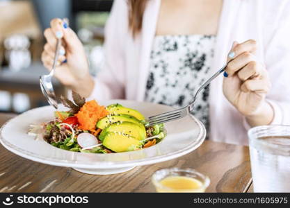 Young woman eating healthy salad at restuarant, Healthy lifestyle, diet concept