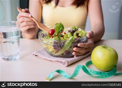 Young woman eating homemade healthy salad at home, Healthy lifestyle, diet concept