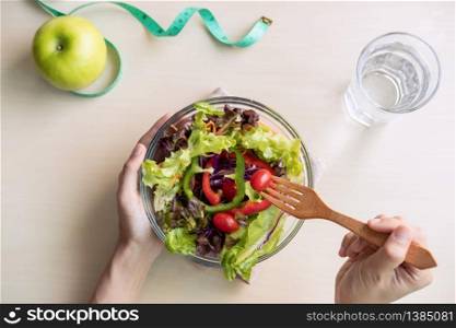 Young woman eating homemade healthy salad at home, Healthy lifestyle, diet concept