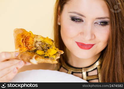 Young woman eating hot fresh pizza slice. Delicious fast food meal. People, italian cuisine concept.. Woman eating hot pizza slice