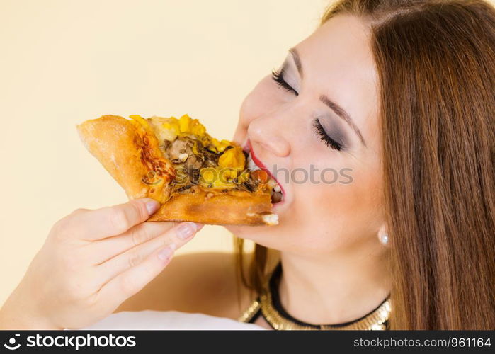 Young woman eating hot fresh pizza slice. Delicious fast food meal. People, italian cuisine concept.. Woman eating hot pizza slice