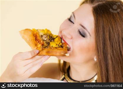 Young woman eating hot fresh pizza slice. Delicious fast food meal. People, italian cuisine concept.. Woman eating hot pizza slice