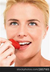 Young Woman Eating Strawberry