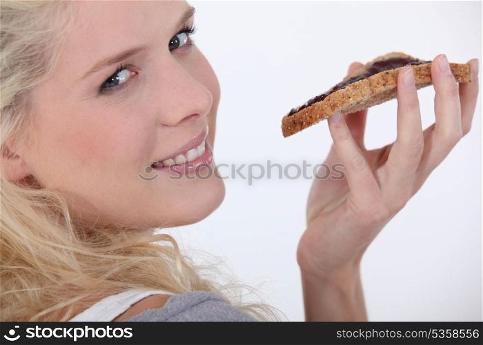 Young woman eating toast