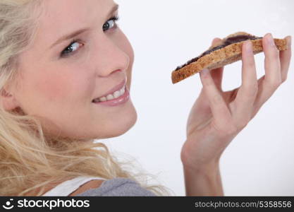 Young woman eating toast