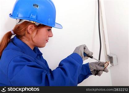 Young woman electrician