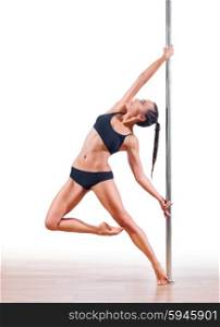 Young woman engaged in pole dancing isolated