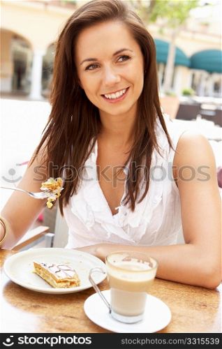 Young Woman Enjoying Coffee And Cake In CafZ