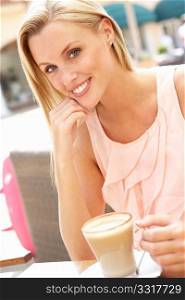 Young Woman Enjoying Cup Of Coffee In CafZ