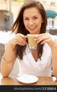 Young Woman Enjoying Cup Of Coffee In CafZ