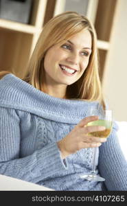 Young Woman Enjoying Glass Of Wine