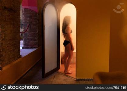 Young woman enjoying hammam or turkish bath with steam. Young woman enjoying hammam or turkish bath