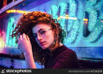 Young woman enjoying lights at night