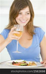 Young Woman Enjoying meal,mealtime With A Glass Of Wine