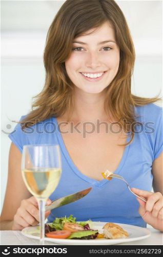 Young Woman Enjoying meal,mealtime With A Glass Of Wine