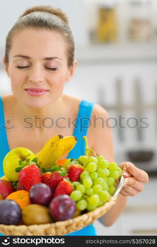 Young woman enjoying plate of fresh fruits