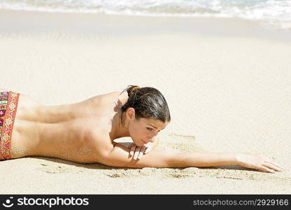 Young woman enjoying sunbath on the beach