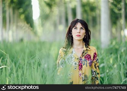 Young woman enjoying the fresh air in green forest.. Woman enjoying the fresh air in green forest.