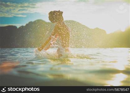 Young woman enjoying the sea at sunset
