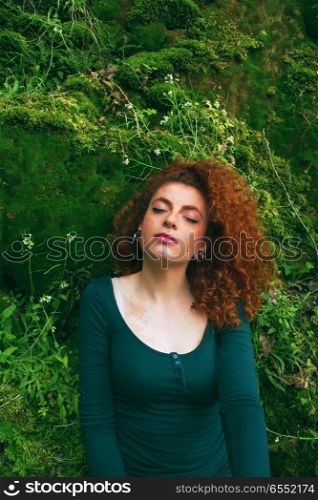 Young woman enjoying the silence in a green and natural place
