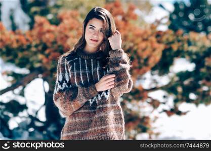 Young woman enjoying the snowy mountains in winter, in Sierra Nevada, Granada, Spain. Female wearing winter clothes.. Young woman enjoying the snowy mountains in winter