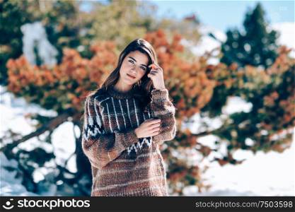 Young woman enjoying the snowy mountains in winter, in Sierra Nevada, Granada, Spain. Female wearing winter clothes.. Young woman enjoying the snowy mountains in winter