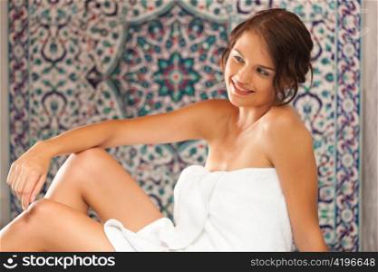Young woman enjoys a steam bath in a thermal bath