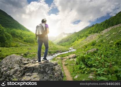 Young woman enjoys view of mountain valley. Nature landscape.