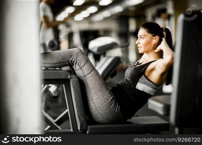 Young woman exercise abs at the gym