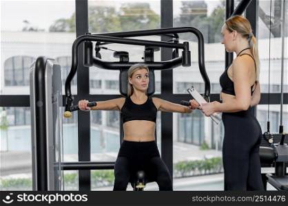 young woman exercising gym long shot