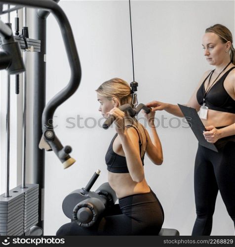young woman exercising gym side view