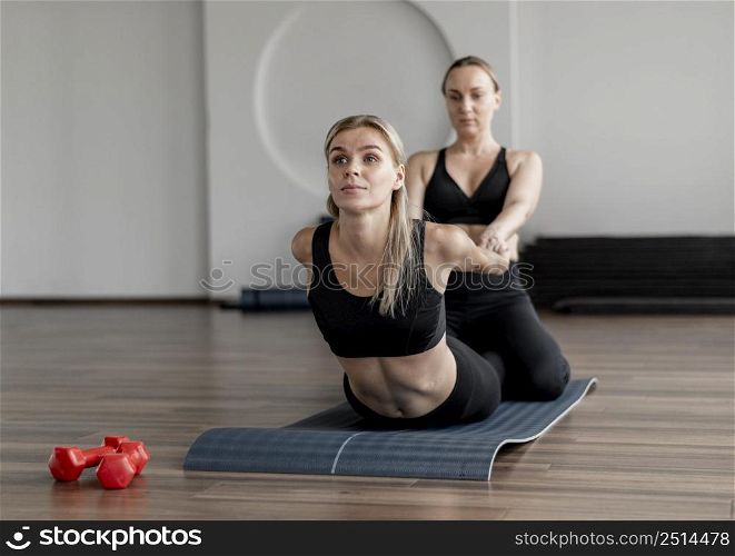 young woman exercising gym stretching
