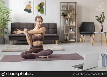 young woman exercising home mat