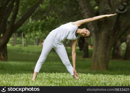 Young woman exercising in a park