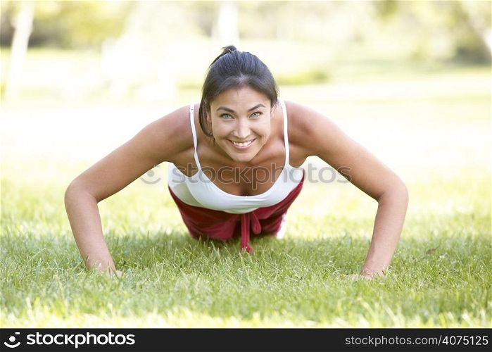 Young Woman Exercising In Park