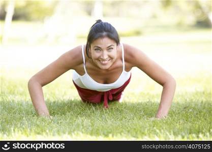 Young Woman Exercising In Park