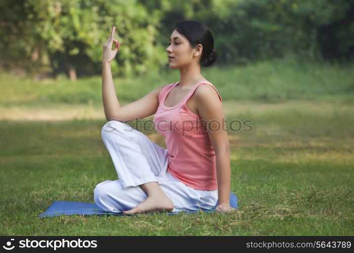 Young woman exercising in park