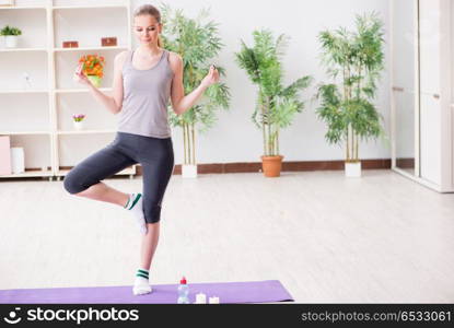 Young woman exercising in sports hall in healthy concept