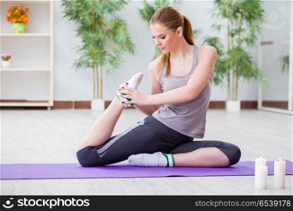 Young woman exercising in sports hall in healthy concept