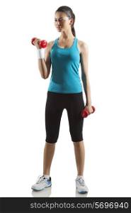 Young woman exercising with dumbbells isolated over white background