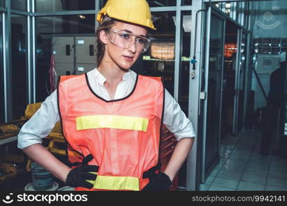 Young woman factory worker close up portrait in manufacturing job factory . Industry and engineering concept .