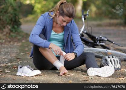 young woman fallen from mountain bicycle