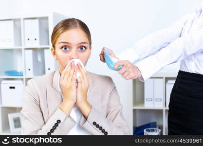 Young woman feeling unwell and sick in office