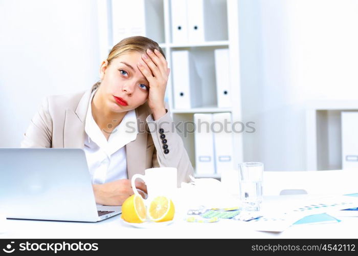 Young woman feeling unwell and sick in office