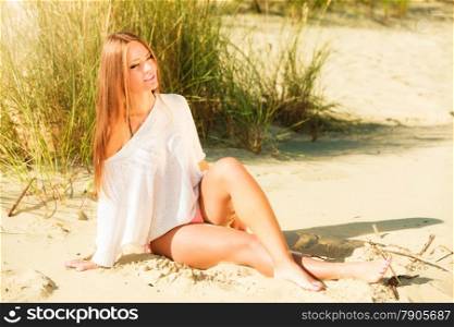 Young woman female model in full length posing outdoor on background of grassy dunes