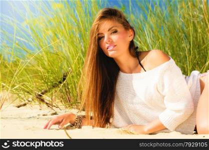 Young woman female model posing outdoor on background of dunes sky and grass