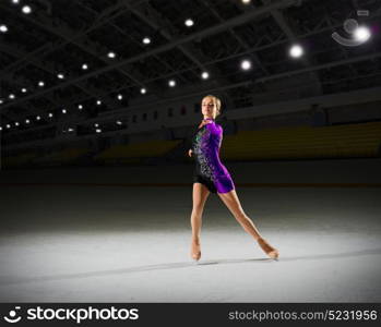 Young woman figure skater at sports hall