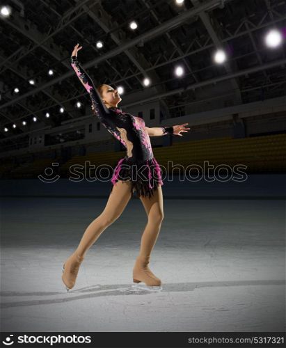 Young woman figure skater at sports hall